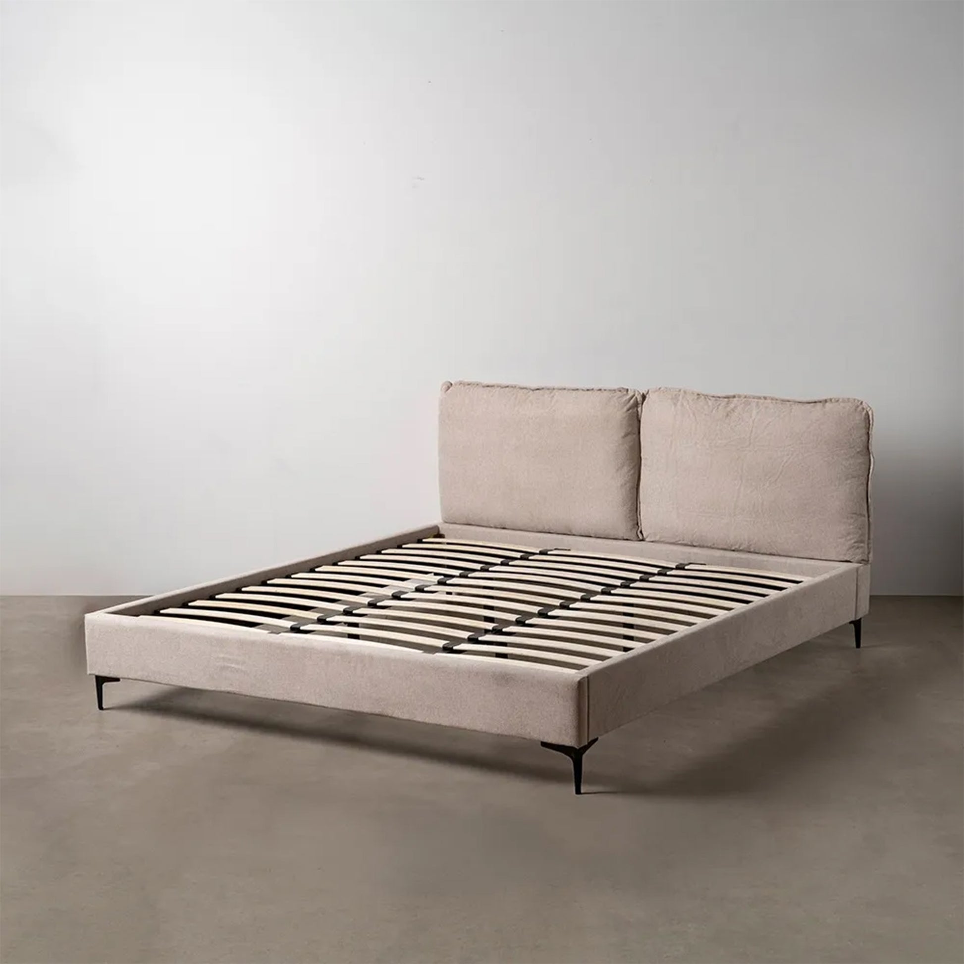 Pablo king size upholstered bed with beige fabric, cushioned headboard and black metal legs