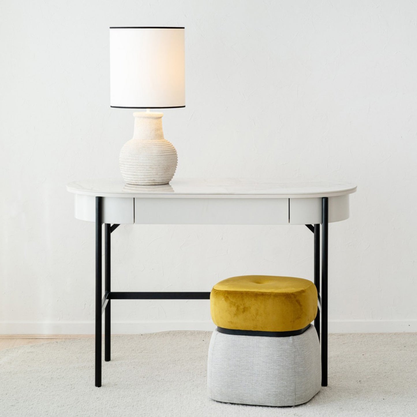 Iker White Ceramic Marble Desk with black legs, oval top, and lacquered drawer