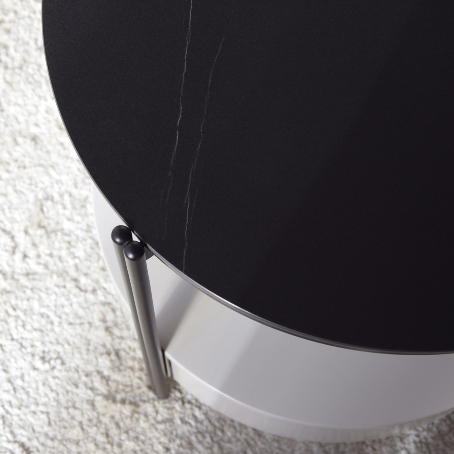 Luis Sintered Stone Black Side Table with round top, matte black frame, and lower drawer