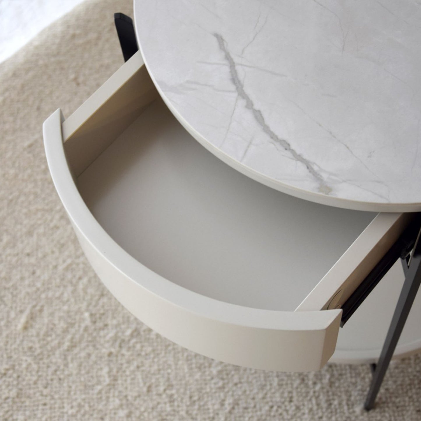 Juan White Ceramic Marble Side Table with round silhouette, drawer, and black metal legs