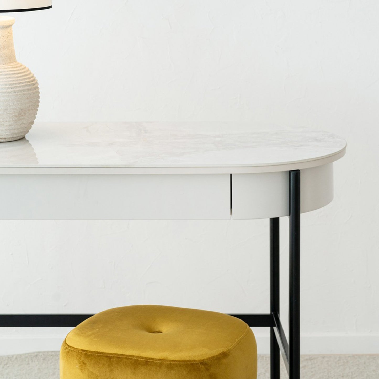 Iker White Ceramic Marble Desk with black legs, oval top, and lacquered drawer