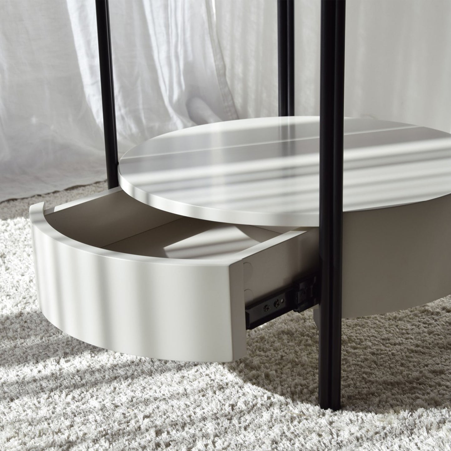 Luis Sintered Stone Black Side Table with round top, matte black frame, and lower drawer
