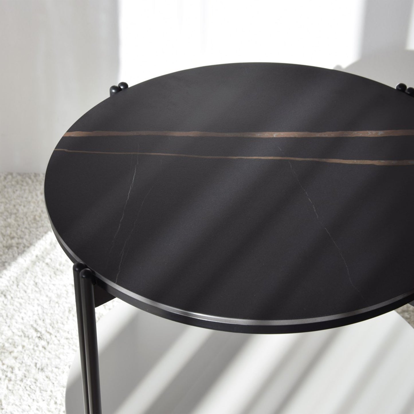 Luis Sintered Stone Black Side Table with round top, matte black frame, and lower drawer
