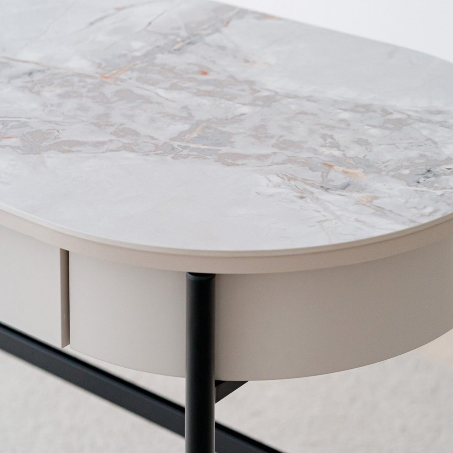 Iker White Ceramic Marble Desk with black legs, oval top, and lacquered drawer