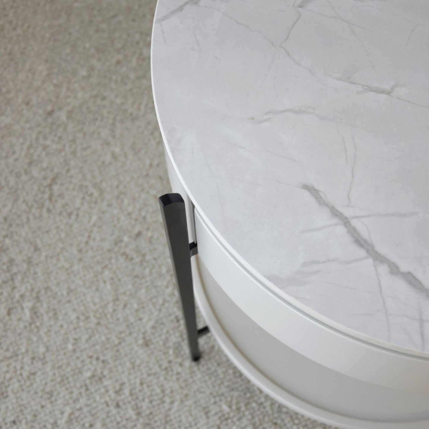 Juan White Ceramic Marble Side Table with round silhouette, drawer, and black metal legs