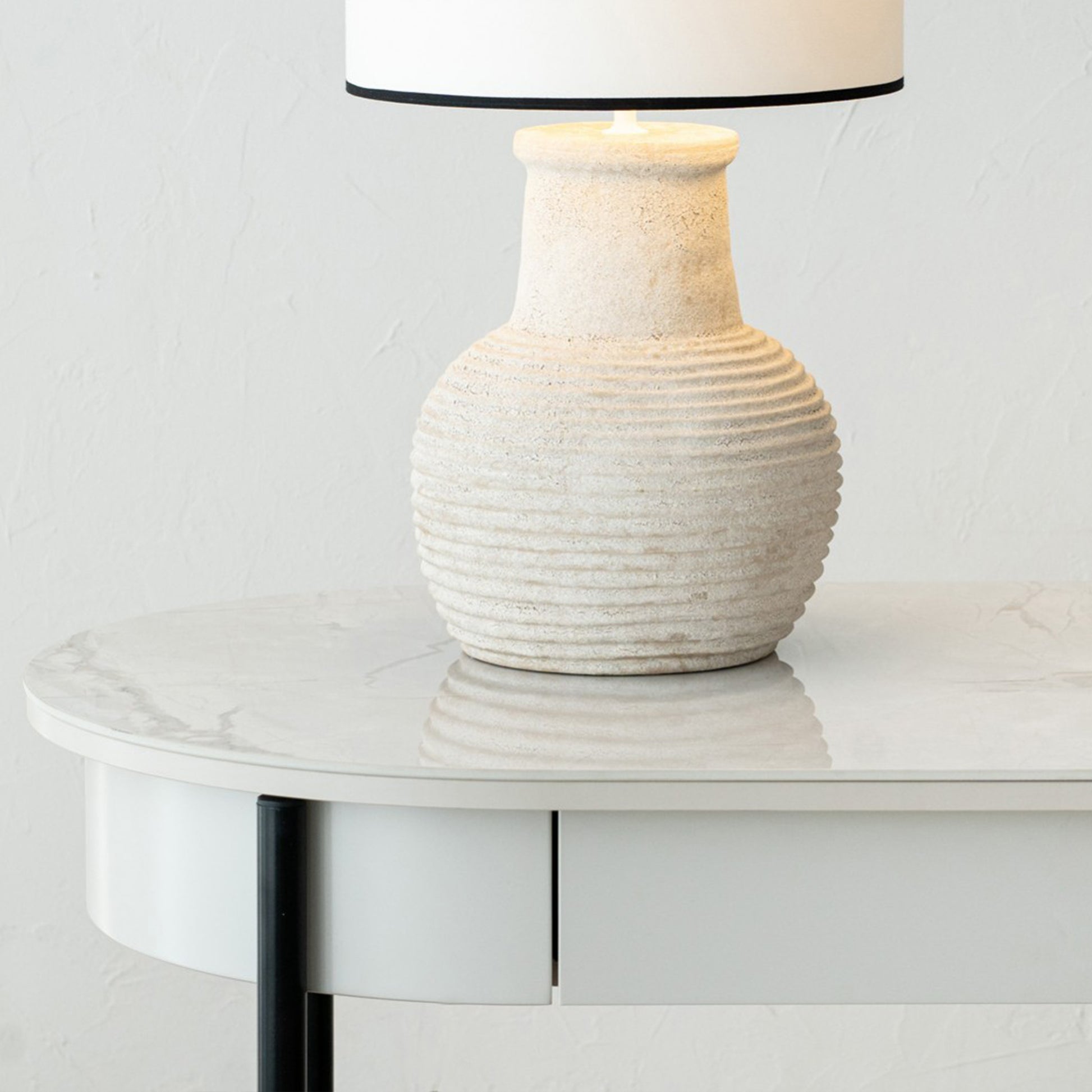Iker White Ceramic Marble Desk with black legs, oval top, and lacquered drawer