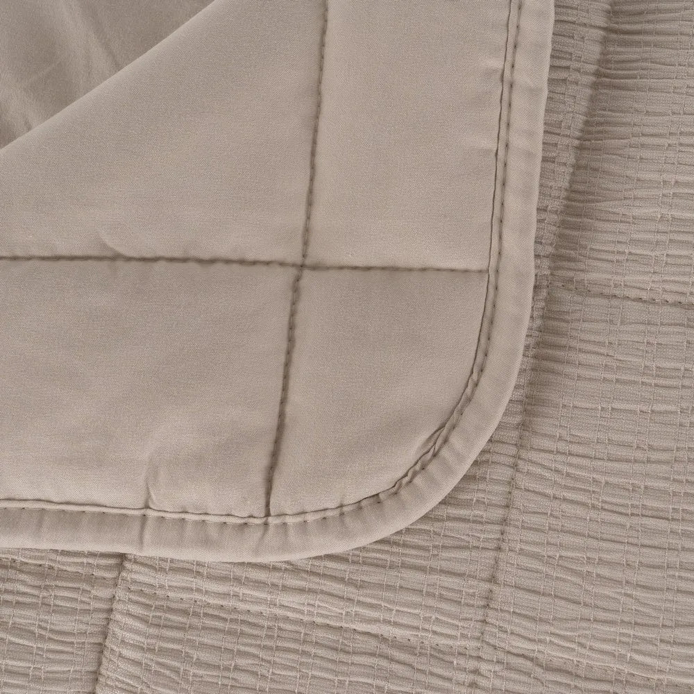 Martina beige and grey polyester quilts neatly folded in a bedroom setting