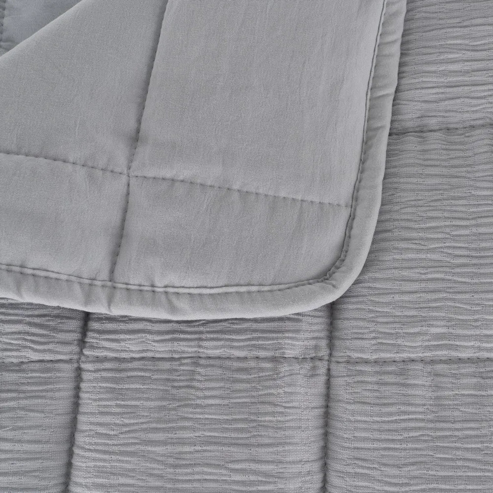 Martina beige and grey polyester quilts neatly folded in a bedroom setting