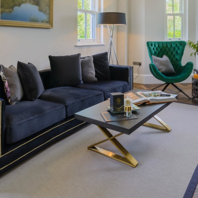 JUDE X-leg coffee table with black wooden top and gold geometric base for modern interiors.