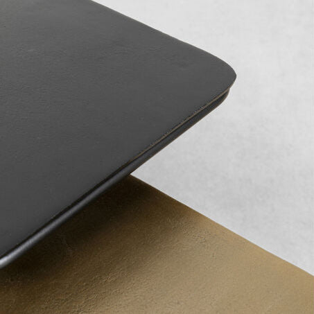 TRAVIS Set of 2 Side Tables with contrasting black and golden tops and sleek black metal frames.