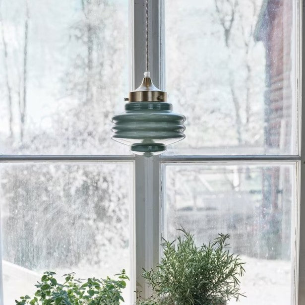 Sculptural opal glass ceiling light with iron fixture and vintage design.