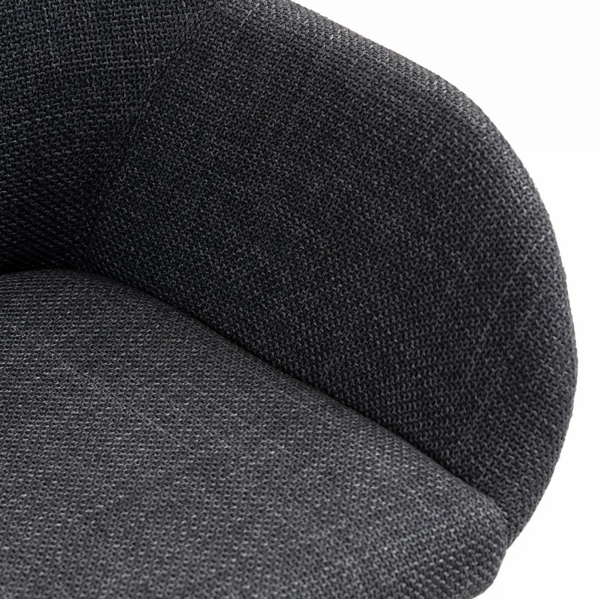 Angled view of ROMA fabric dining chair with dark oak wooden legs and curved armrest design