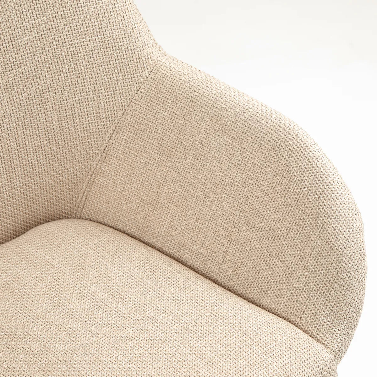 Angled view of ROMA fabric dining chair with dark oak wooden legs and curved armrest design