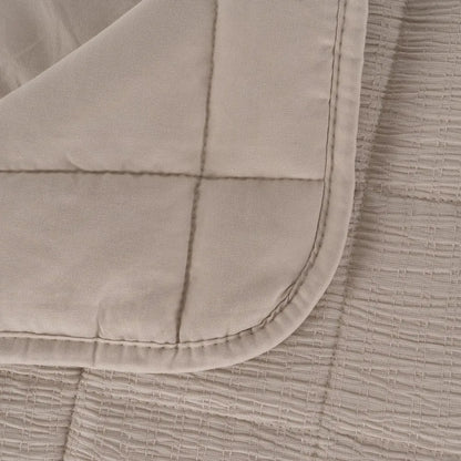 Martina beige and grey polyester quilts neatly folded in a bedroom setting