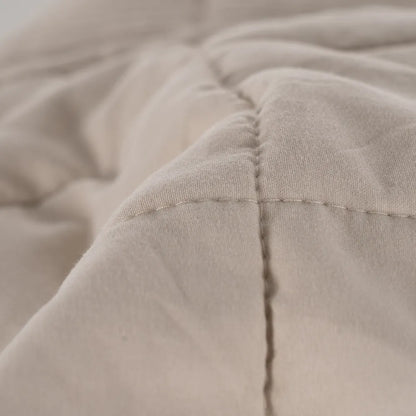 Martina beige and grey polyester quilts neatly folded in a bedroom setting