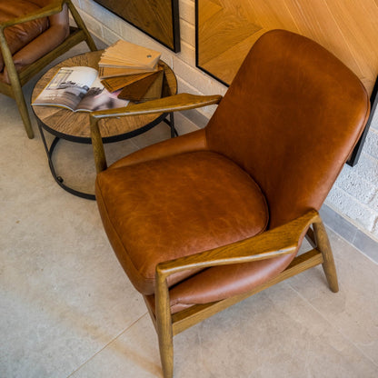 SANDRA leather armchair with solid oak frame, mid-century modern design, and premium padded cushions for luxurious comfort.