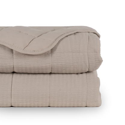 Martina beige and grey polyester quilts neatly folded in a bedroom setting